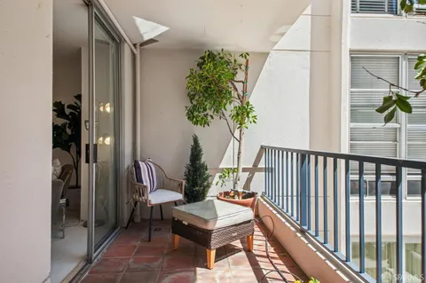 a living room with furniture potted plant and a window