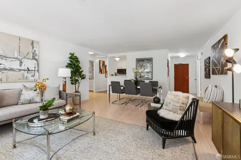 a living room with furniture and painting on the wall