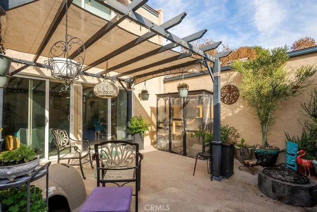 a building outdoor space with patio furniture and potted plants