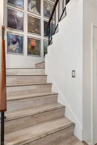 a view of staircase with white walls and windows
