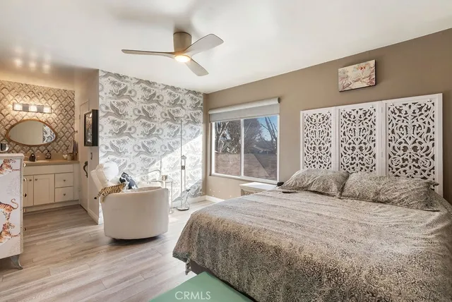 a bedroom with a large bed and a chandelier