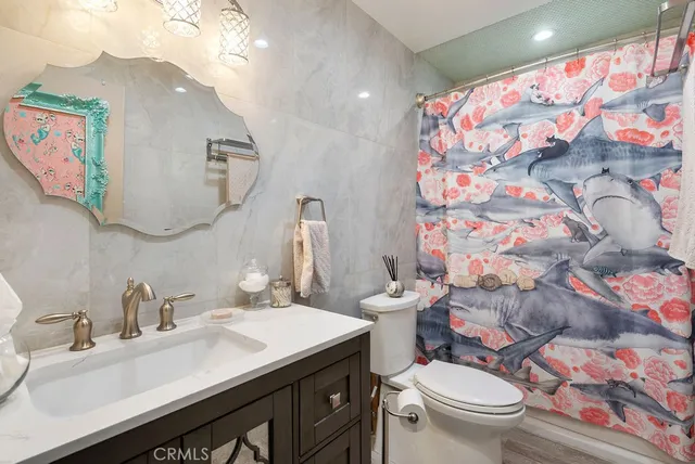 a bathroom with a sink mirror vanity and toilet