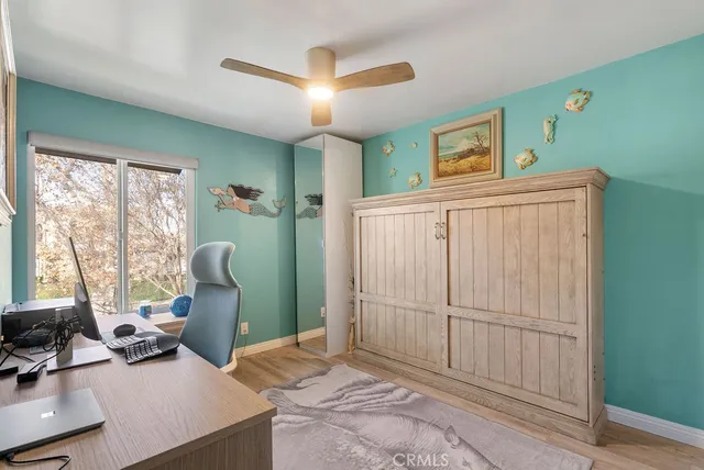 a bedroom with furniture and a large window