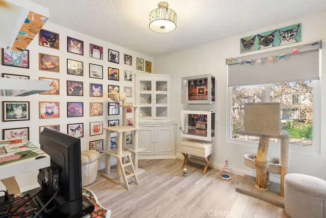 a view of a livingroom with workspace and a window