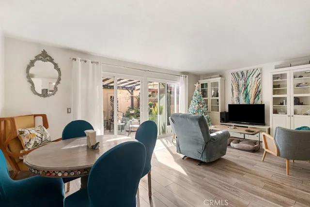 a living room with furniture floor to ceiling window and a flat screen tv