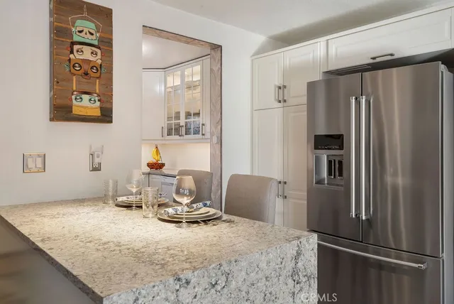 a kitchen with a refrigerator and a refrigerator