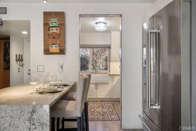 a view of a dining room with furniture and a chandelier