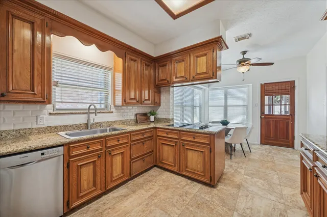 a kitchen with a sink stove and cabinets