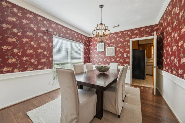 a dining room with furniture a chandelier and window