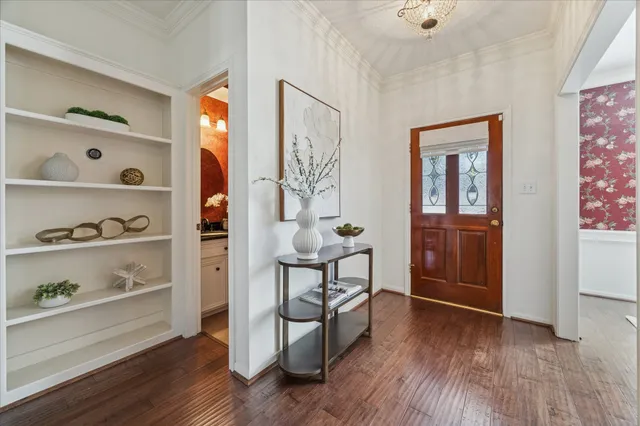 a view of a livingroom with wooden floor and furniture