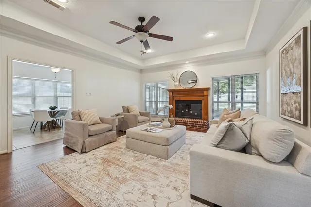 a living room with furniture a fireplace and a large window