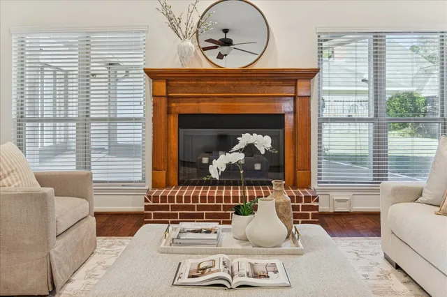 a living room with furniture a fireplace and window