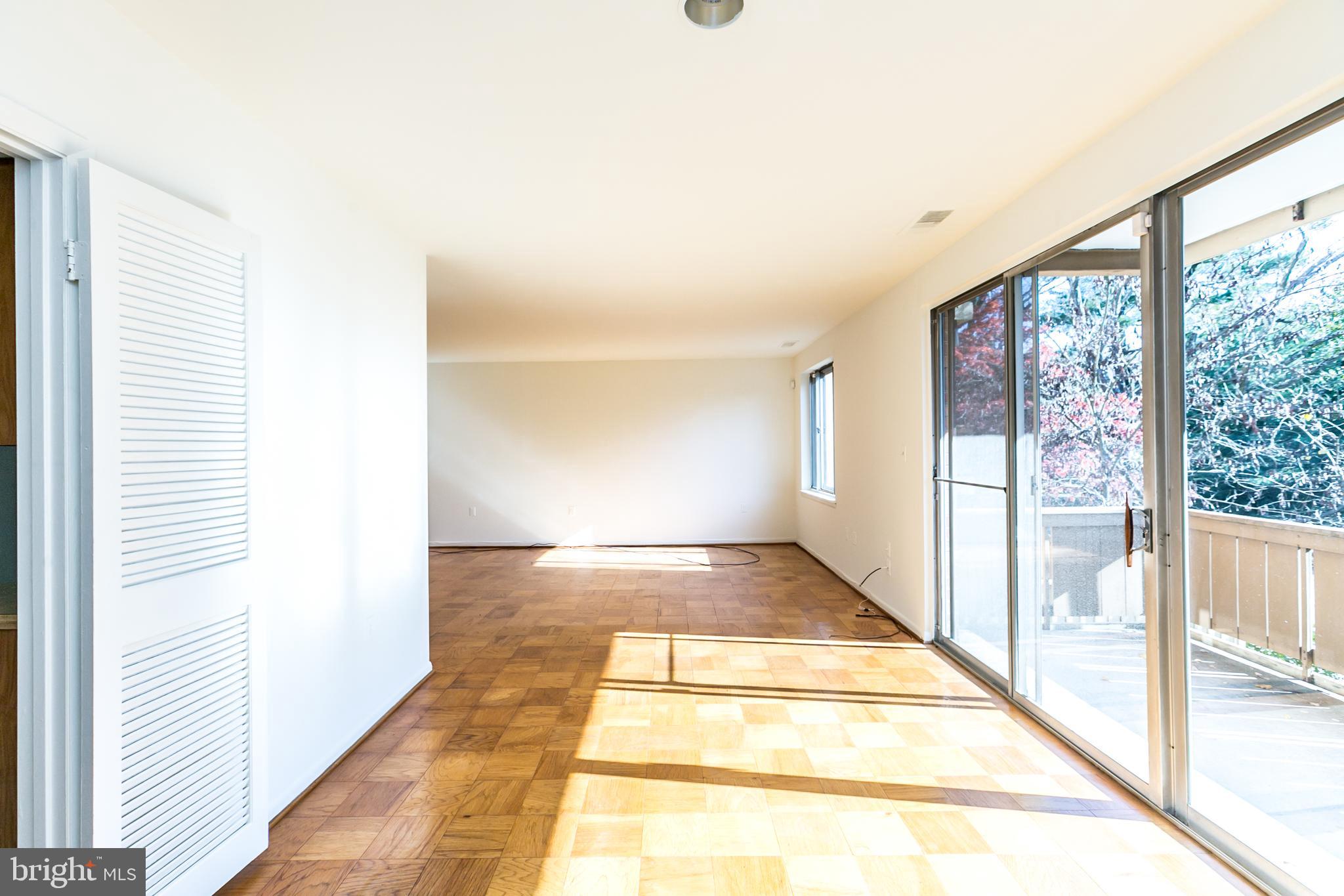 7 Hamill Road, Unit 7C Baltimore, MD 21210 - Photo 7 of 23 Sliders to balcony off of the dining room