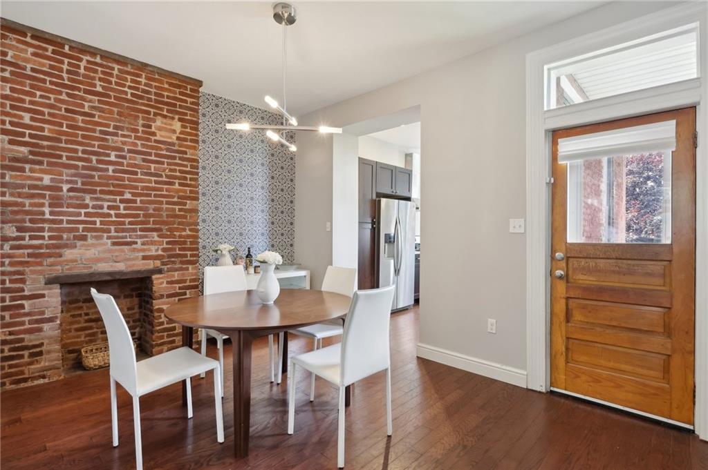 5259 Carnegie Street Lawrenceville, PA 15201 - Photo 11 of 50 a view of a dining room with furniture and wooden floor
