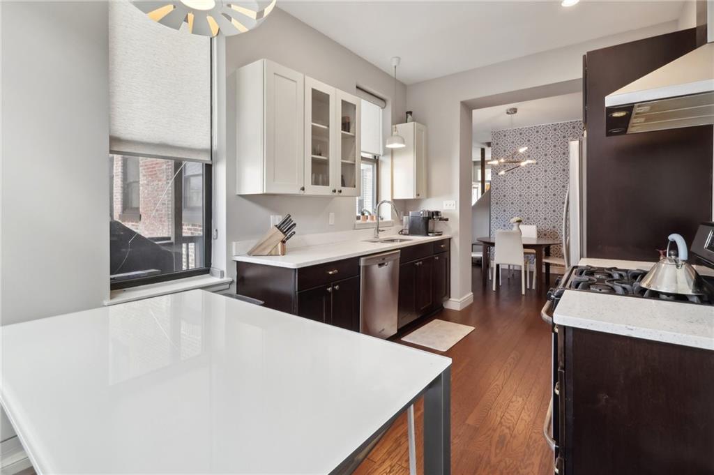 5259 Carnegie Street Lawrenceville, PA 15201 - Photo 15 of 50 a large white kitchen with a sink and cabinets