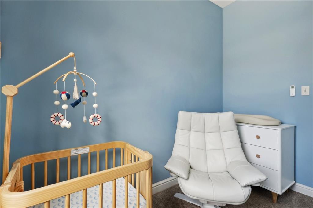 5259 Carnegie Street Lawrenceville, PA 15201 - Photo 29 of 50 a bedroom with furniture and a lamp