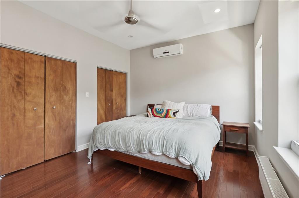 5259 Carnegie Street Lawrenceville, PA 15201 - Photo 32 of 50 a bedroom with a bed and wooden floor