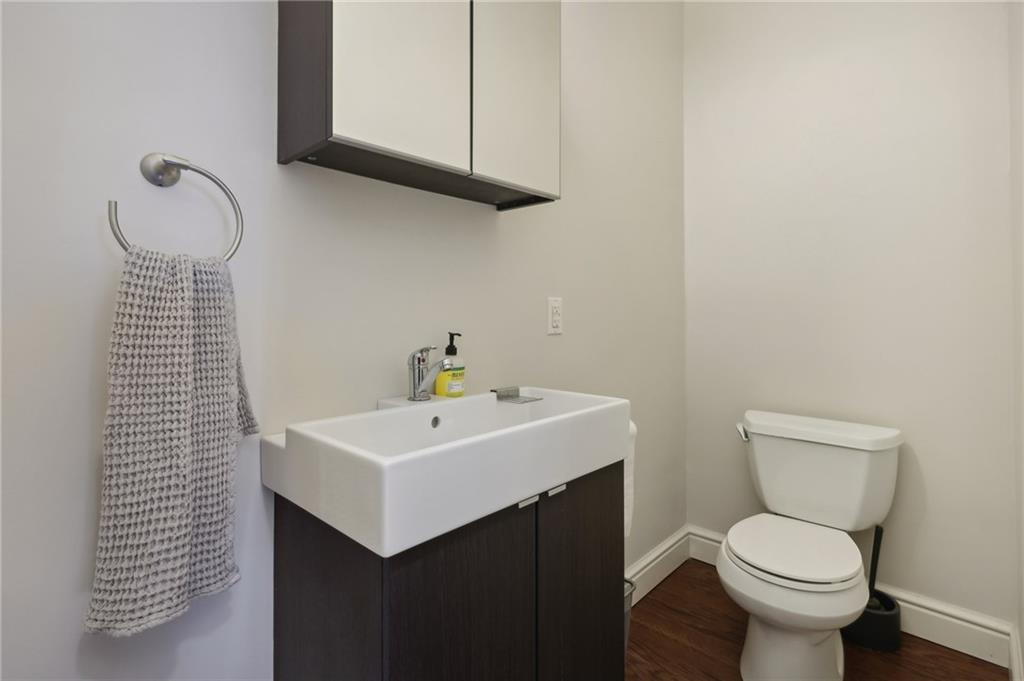 5259 Carnegie Street Lawrenceville, PA 15201 - Photo 36 of 50 a bathroom with a toilet sink and mirror