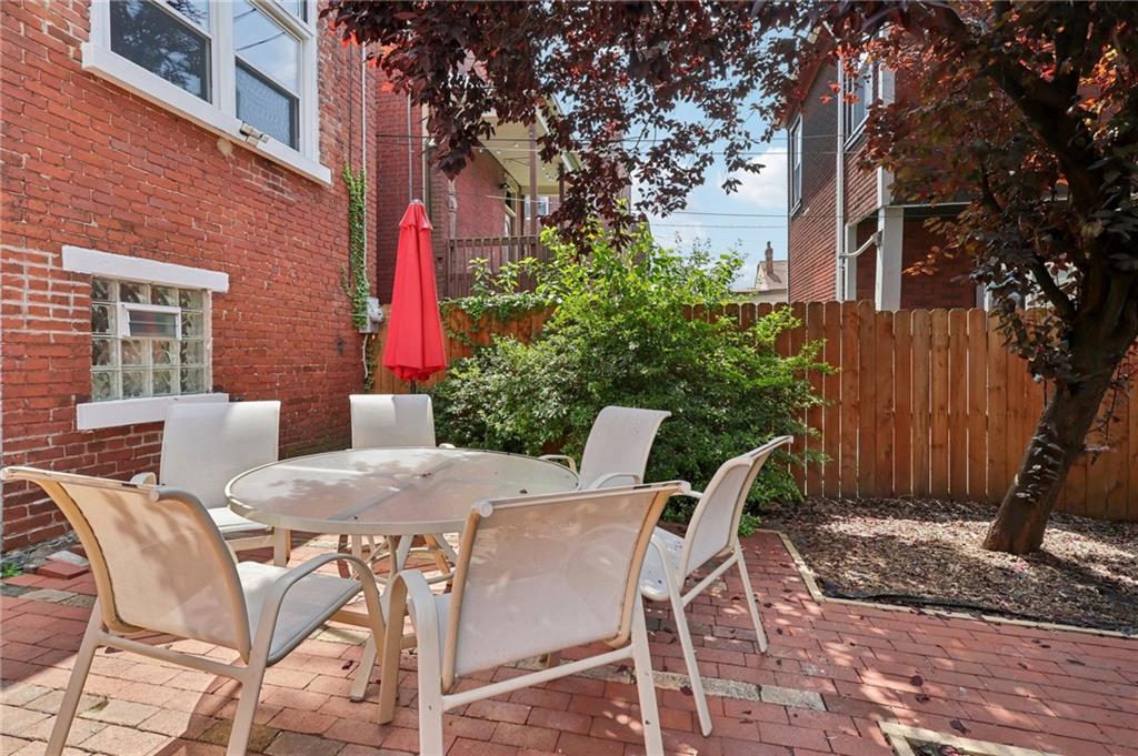 5259 Carnegie Street Lawrenceville, PA 15201 - Photo 42 of 50 a patio with a table and chairs and potted plants