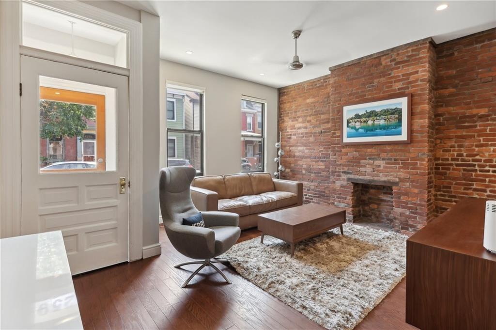 5259 Carnegie Street Lawrenceville, PA 15201 - Photo 7 of 50 a living room with furniture and a fireplace