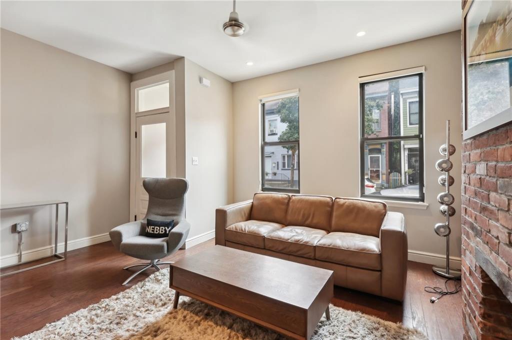 5259 Carnegie Street Lawrenceville, PA 15201 - Photo 8 of 50 a living room with furniture and a fireplace