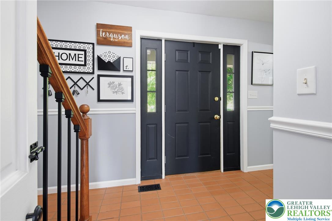 890 Lahr Road Nazareth, PA 18064 - Photo 6 of 71 A welcoming entry features terra cotta tile flooring and a substantial dark entry door with transom windows.
