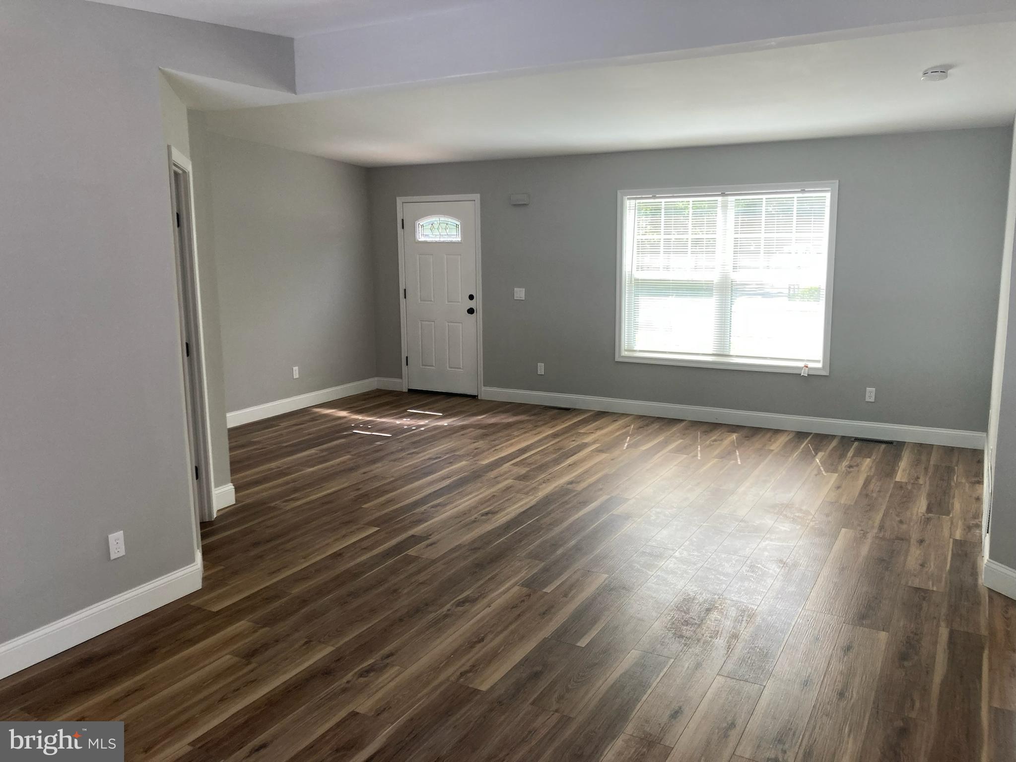 9 King Drive Bridgeton, NJ 08302 - Photo 8 of 16 a view of an empty room with wooden floor and a window