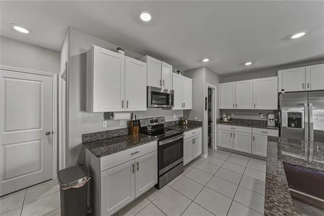 a dining hall with couches a dining table and chairs with wooden floor