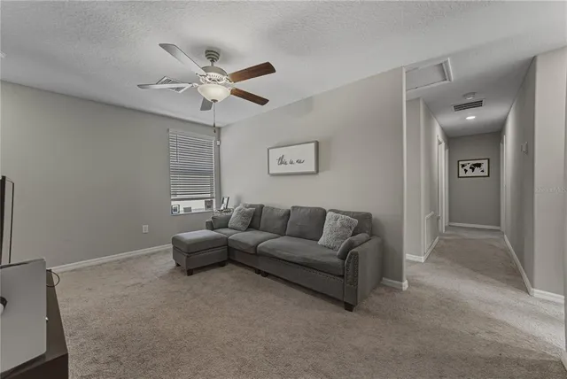 a spacious bathroom with a granite countertop sink a toilet and a mirror