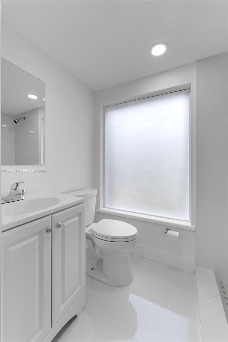 9840 Southwest 60th Street Miami, FL 33173 - Photo 17 of 37 a bathroom with a sink a toilet and a mirror