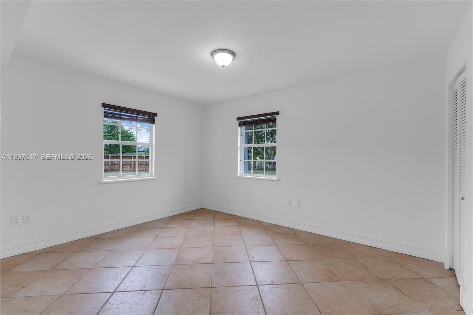 9840 Southwest 60th Street Miami, FL 33173 - Photo 18 of 37 a view of an empty room with a window