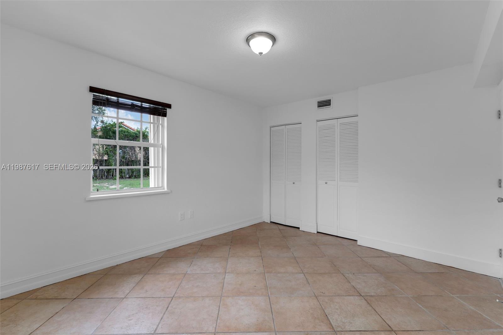 9840 Southwest 60th Street Miami, FL 33173 - Photo 19 of 37 a view of an empty room with a window