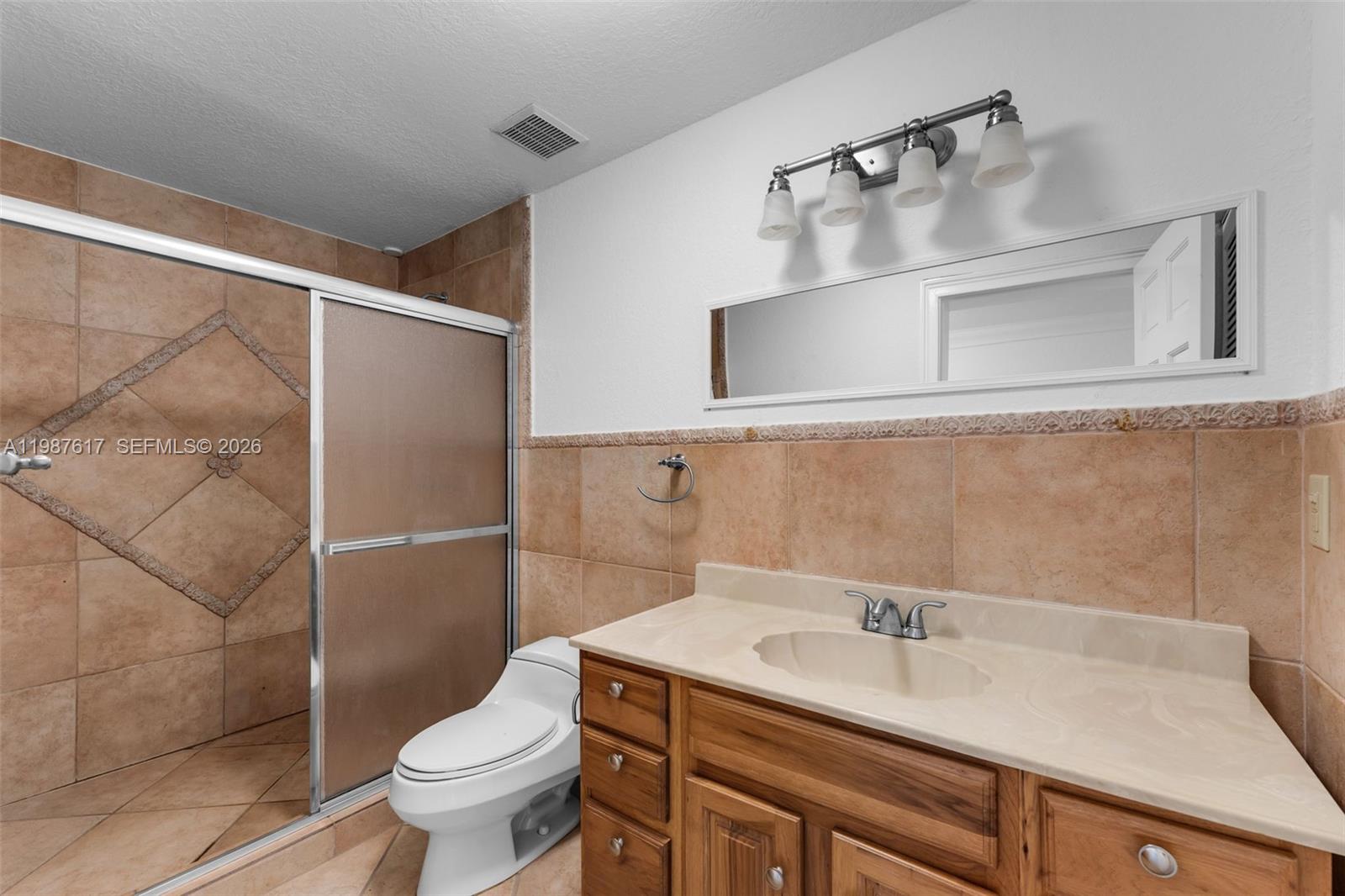 9840 Southwest 60th Street Miami, FL 33173 - Photo 20 of 37 a bathroom with a sink toilet and shower
