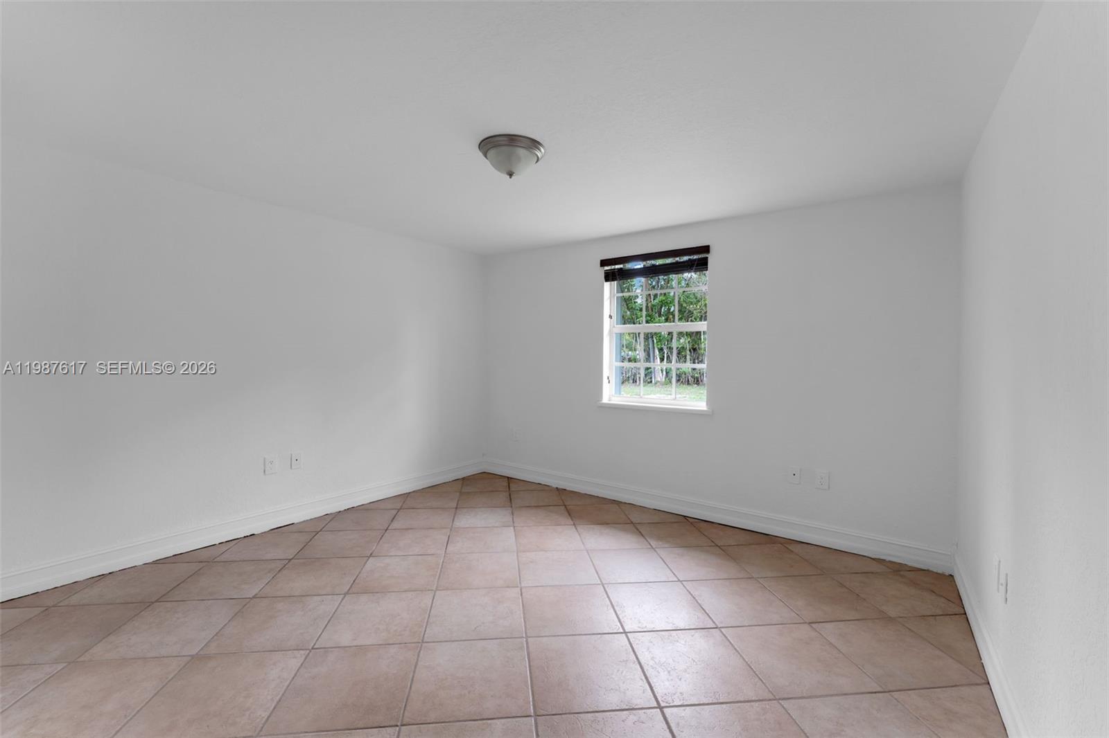 9840 Southwest 60th Street Miami, FL 33173 - Photo 21 of 37 an empty room with a empty space and a window