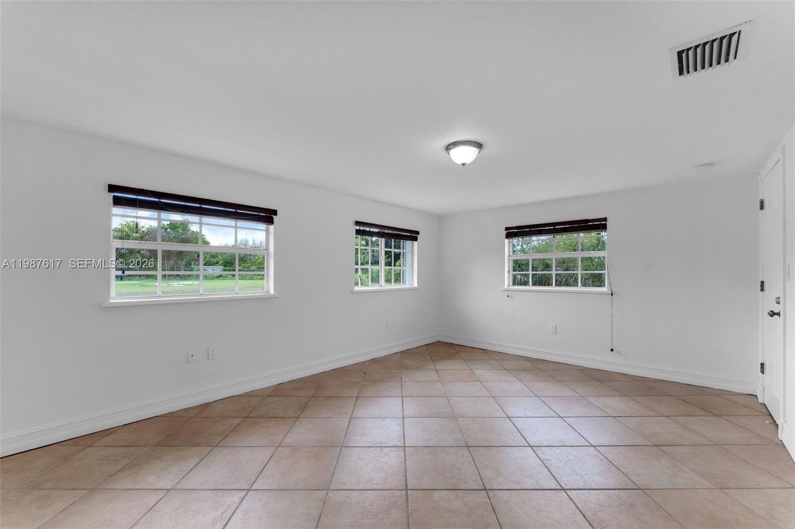 9840 Southwest 60th Street Miami, FL 33173 - Photo 24 of 37 an empty room with windows