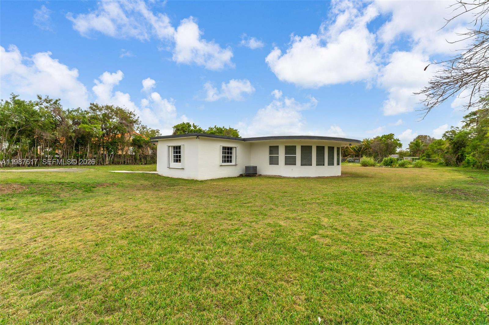 9840 Southwest 60th Street Miami, FL 33173 - Photo 6 of 37 a view of a house with a big yard