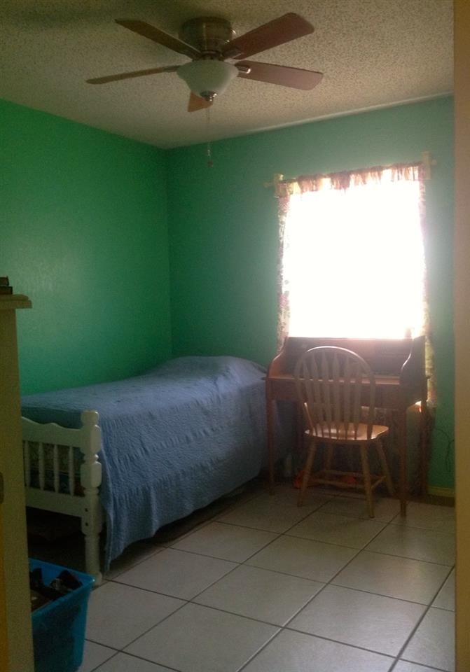 10203 Center Road Laredo, TX 78045 - Photo 3 of 9 a bedroom with a bed and a window