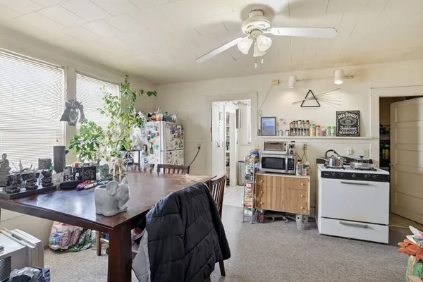a kitchen with refrigerator cabinets and dining table