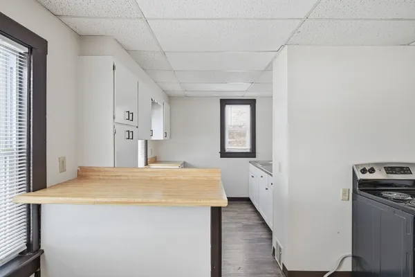 a room with a refrigerator and mirror