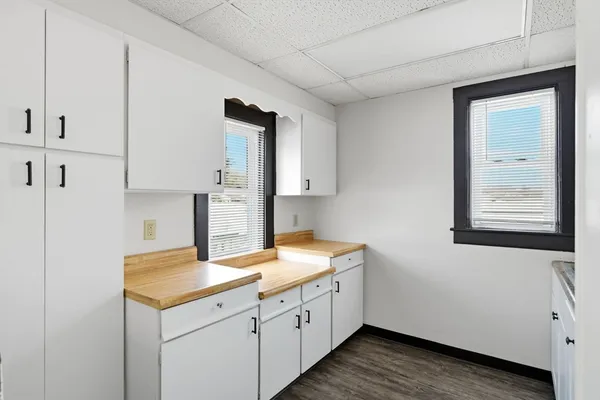 a utility room with cabinets washer and dryer