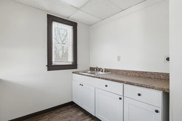 a bathroom with a granite countertop sink and window