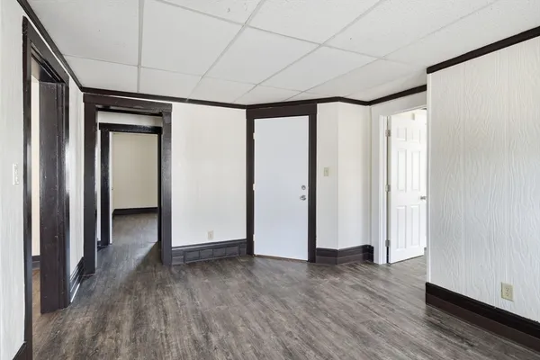 an empty room with wooden floor and a window