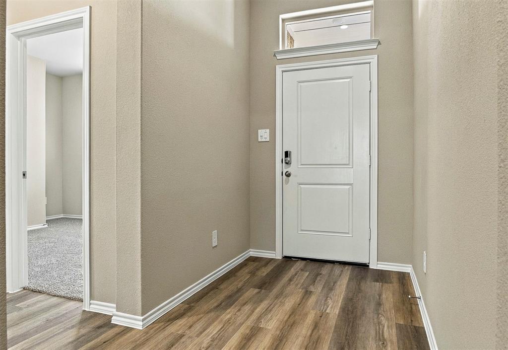 15932 Stableford Road Justin, TX 76247 - Photo 4 of 35 Entryway featuring wood-finish flooring and a white paneled door.