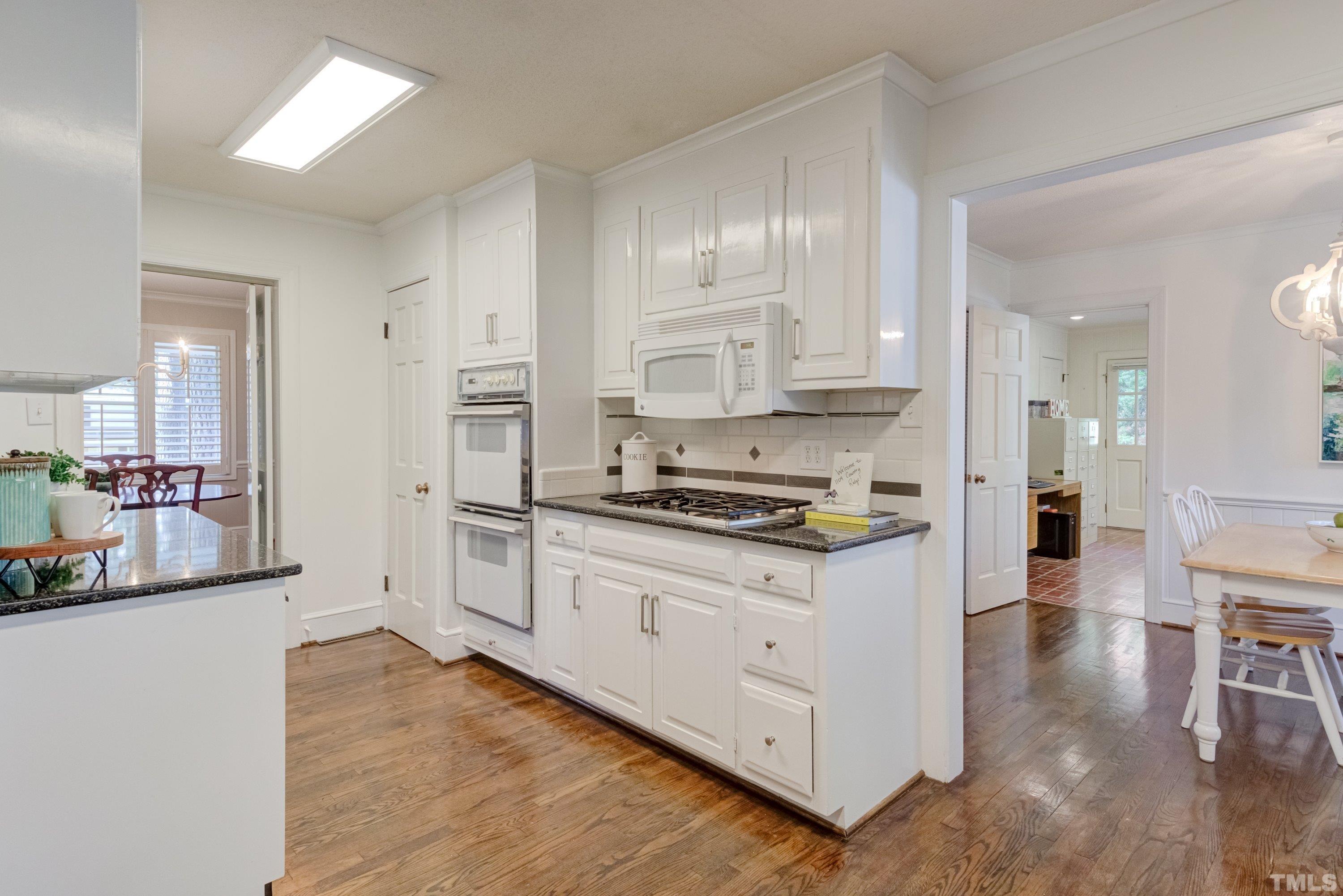 1109 Country Ridge Drive Raleigh, NC 27609 - Photo 15 of 64 a kitchen with stainless steel appliances granite countertop a stove and a refrigerator