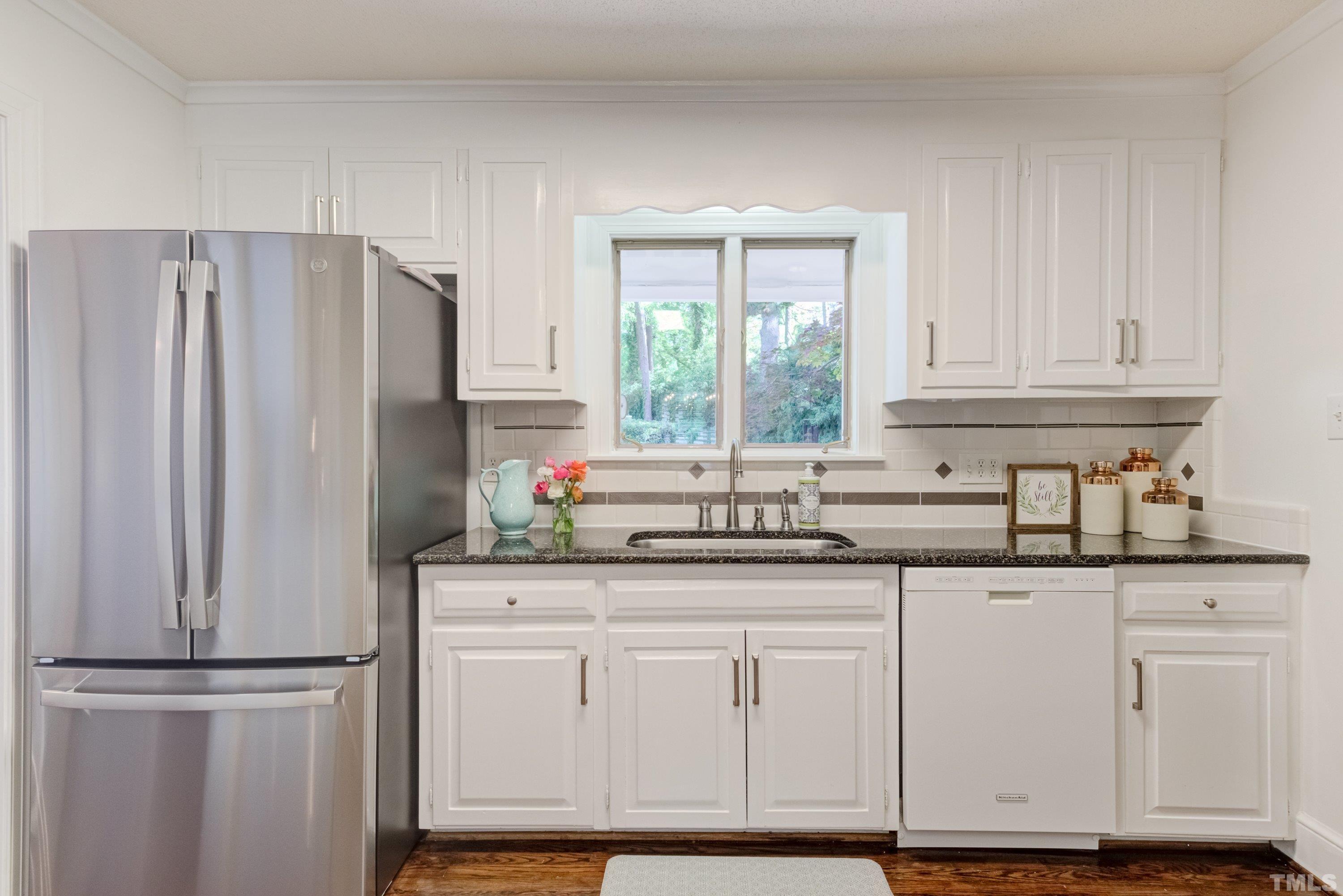 1109 Country Ridge Drive Raleigh, NC 27609 - Photo 19 of 64 a kitchen with white cabinets and a refrigerator