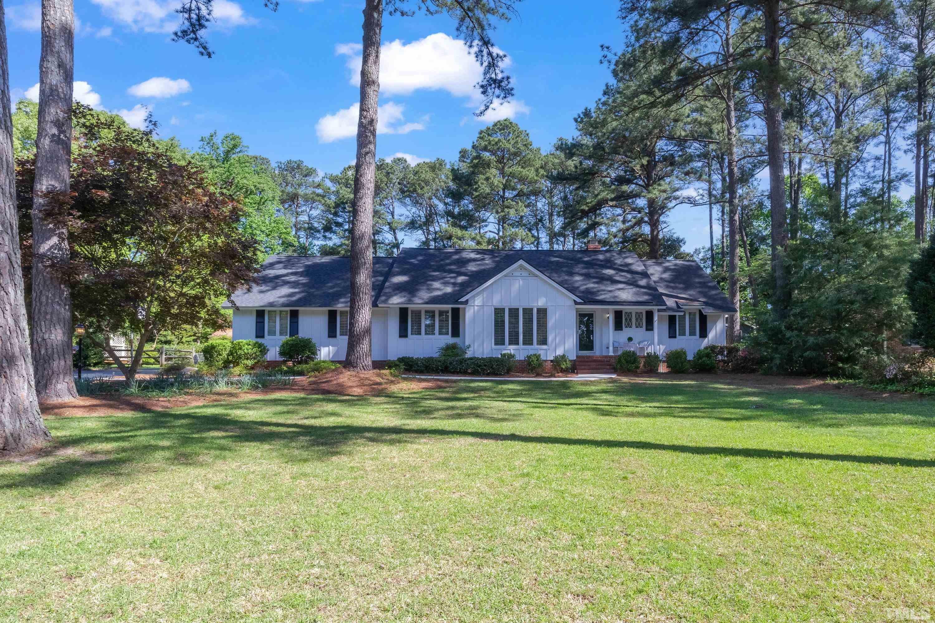 1109 Country Ridge Drive Raleigh, NC 27609 - Photo 2 of 64 a view of a big house with a big yard and potted plants and large trees