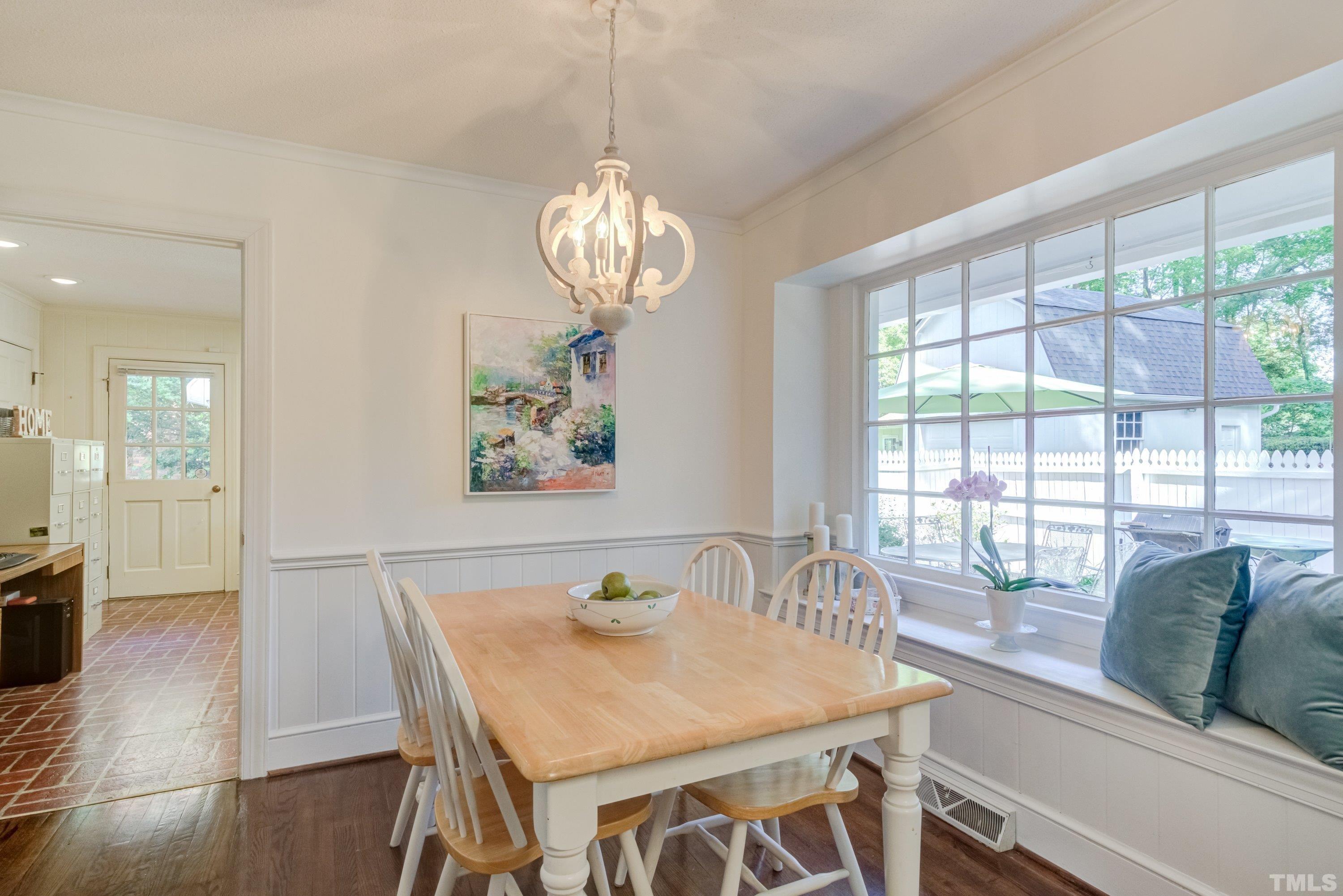 1109 Country Ridge Drive Raleigh, NC 27609 - Photo 22 of 64 a view of a dining room with furniture wooden floor and chandelier
