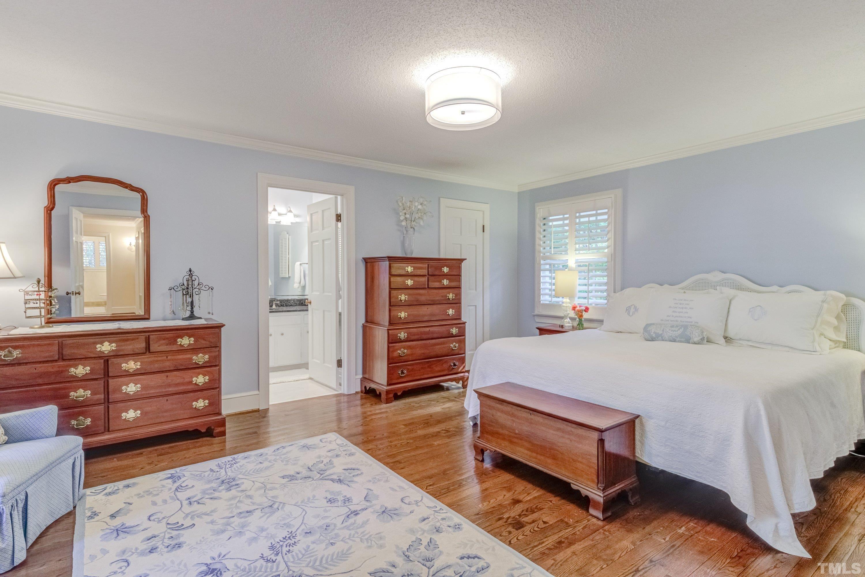 1109 Country Ridge Drive Raleigh, NC 27609 - Photo 26 of 64 a bedroom with a bed and a dresser in it