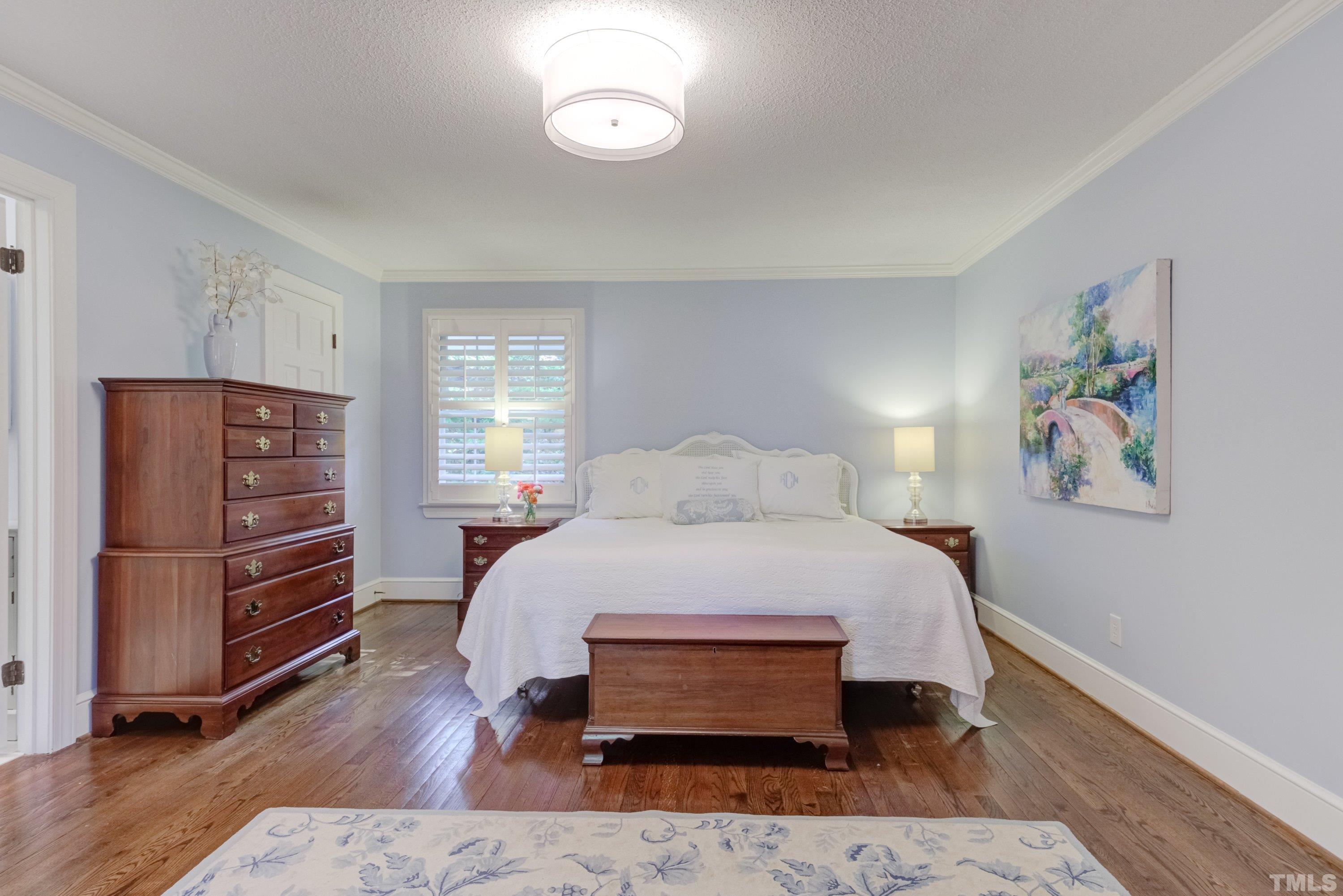 1109 Country Ridge Drive Raleigh, NC 27609 - Photo 27 of 64 a bedroom with a bed and wooden floor