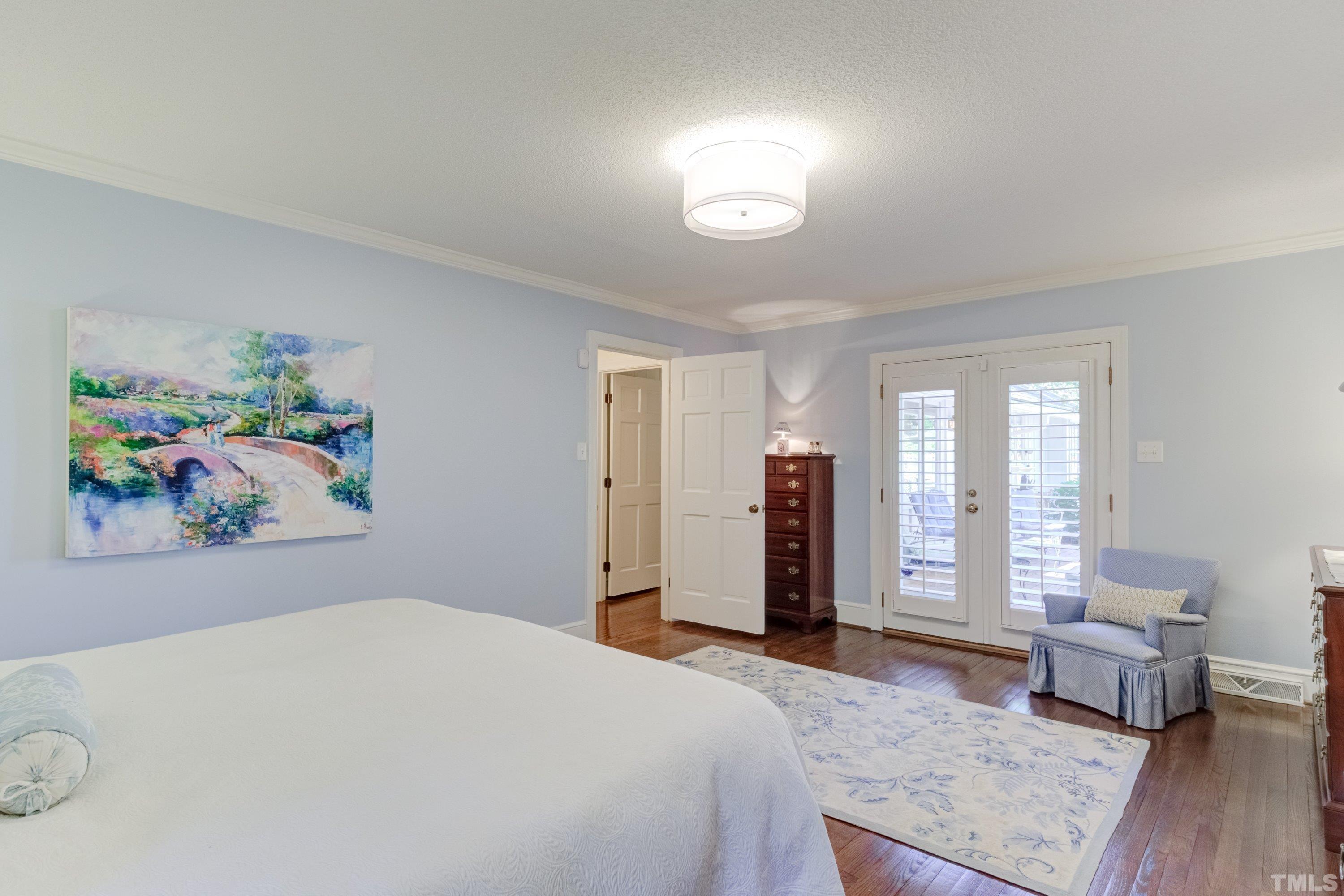 1109 Country Ridge Drive Raleigh, NC 27609 - Photo 30 of 64 a bedroom with a bed and wooden floor